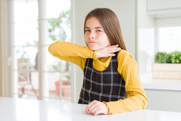 young beautiful blonde kid girl wearing casual yellow sweater at home cutting throat with hand as kn