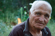 © Sahaidachnyi Roman - Close-up portrait of a very old man on a blurred background of green trees, selective focus