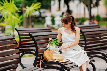 Wall Mural - Woman with reusable water bottle and bamboo handbag, cotton grocery bag with vegetables in park. Summer Vacation concept