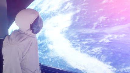 Wall Mural - alone astronaut in futuristic interior. view of the earth. 3d rendering