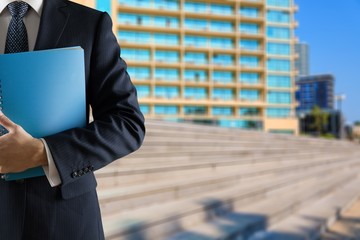 Wall Mural - Male businessman with notebook report on grey background