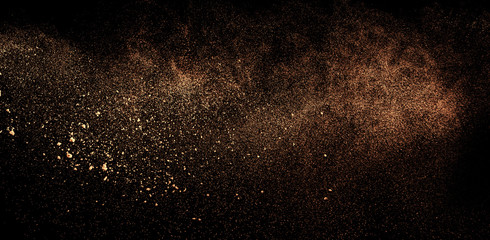 Wall Mural - a shot from a firearm, an explosion of gunpowder on a black background, a bright flash with flying particles, abstract shape