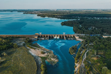 Aerial Panoramic View Of Concrete Dam At Reservoir With Flowing Water, Hydroelectricity Power Station