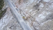 Large Excavators Eliminate Effects Of Rocks Stones Landslide On Road At High Mountain Foot Upper View. Concept Transport Routes And Annual Natural Disasters