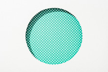 Cut Out Round Hole In White Paper On Green Dotted Background