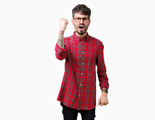 Sticker - Young handsome man wearing glasses over isolated background angry and mad raising fist frustrated and furious while shouting with anger. Rage and aggressive concept.