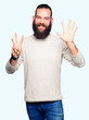 © Krakenimages.com - Young blond man wearing casual sweater showing and pointing up with fingers number eight while smiling confident and happy.