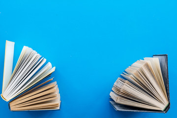 Books on library desk for reading and education on blue background top view mockup