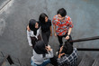 © Odua Images - chatting with friends on the stairs when hanging out together
