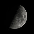 moon first quarter phase,  fifty percent lighted by the the sun, view from Northern Hemisphere, black background, taken with a 2500mm telescope focal lenght