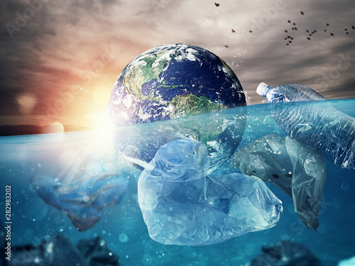 Fotomural The Earth floats in the sea full of plastic
