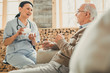 © zinkevych - Pleasant dark-haired woman in blue confidently talking to patient