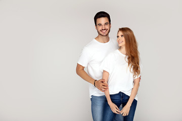 Happy youg couple posing together in studio.