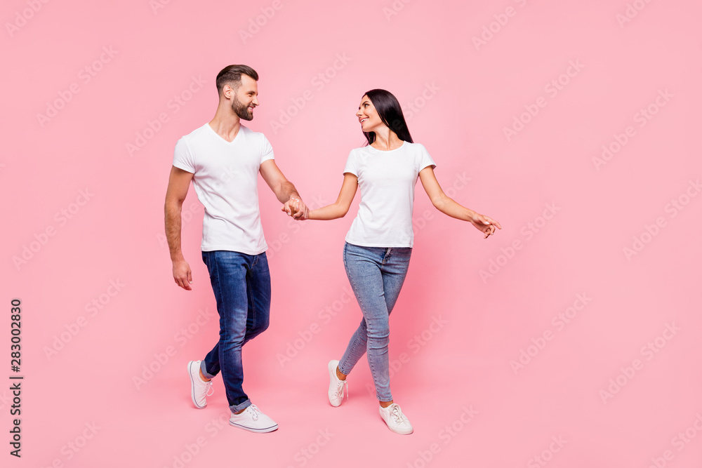 Full length body size photo of couple walking streets of town they have just arrived in while isolated with pastel background - obrazy, fototapety, plakaty 
