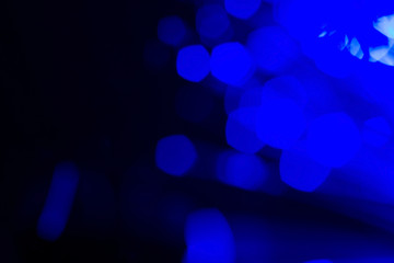 Wall Mural - Blue bokeh lights on dark background; abstract background