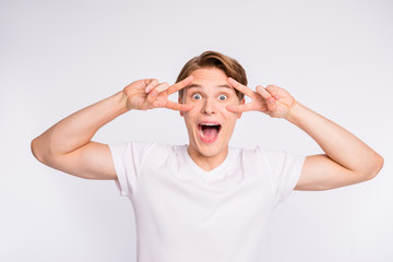 Wall Mural - Close-up portrait of his he nice cute attractive cheerful cheery positive optimistic crazy guy showing double v-sign near eyes isolated over light white pastel background