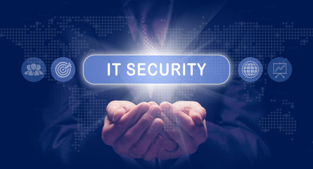 Businessmans cupped hands holding an IT Security business concept on a computerised display.