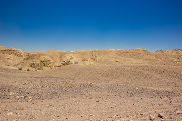 desert valley wasteland scenic landscape view of nothing with sand stone bare mountain ridge background