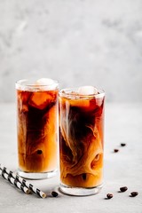 Wall Mural - Caramel vanilla iced coffee with ice cubes in tall glasses