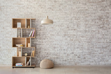 Interior Of Modern Room With Bookcase, Pouf And Lamp