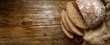 Bread,  traditional spelled sourdough bread cut into slices on a rustic wooden background, close-up, top view, copy space. Concept of traditional leavened bread baking methods