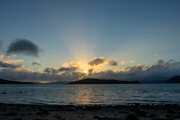 Wall Mural - Islands and Sea with Sunset in the Background