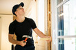 © Louis-Paul Photo - A handsome young man installing Double Sliding Patio Door in a new house construction site
