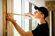 © Louis-Paul Photo - A handsome young man installing Double Sliding Patio Door in a new house construction site