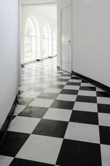 White art-deco hall with black and white floor tiles