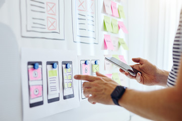 Wall Mural - web developer with mobile phone planning website ux app development on white board