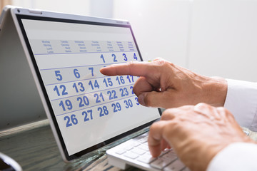 Businessman Using Calendar On Laptop