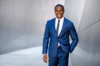 © elnariz - Stylish chic modern style business suit executive, african american male commercial model, walking to swanky office workplace