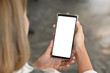 © Prathankarnpap - Young woman's hands holding empty screen of smartphone.