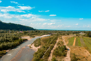 Beautiful landscape from the top shows the river and field in the countryside.