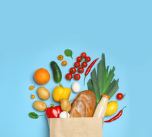 Shopping Paper Bag With Different Groceries On Light Blue Background, Flat Lay
