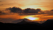 © Chamois huntress - beautiful sunset in the mountains with orange sky and view to the alps