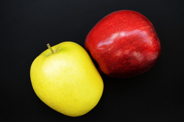 Red and yellow apples on a dark background close-up