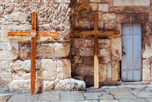 A Steel Door And Two Big Christian Wooden Crosses Lean Against Stone Wall Of The Church Of The Holy Sepulchre In Old City Of Jerusalem, Israel. Via Dolorosa. Jesus Christ