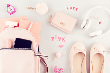 Flat lay with girls spring summer accessories in pink pastel tones.