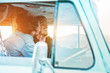 © DisobeyArt - Happy couple inside minivan doing a road trip - Woman with freckles having fun on summer vacation traveling with her boyfriend - Van lifestyle, love and holiday concept - Focus on girl head