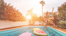 Happy Friends Drinking Jumping In Swimming Pool At Sunset - Young  People Having Fun In Tropical Vacation - Summer Holiday, Youth And Friendship Concept - Soft Focus On Close-up Girl