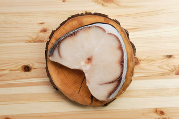 Sticker - Frozen blue shark steak on wooden table