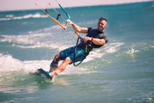 Kitesurfing. Man Rides On Kite On Waves
