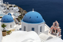 Greece. Cyclades Islands - Santorini (Thira). Oia Town With Typical Cycladic Architecture - Painted Blue Cupolas And White Walls Of Houses. The Anastasis Church.
