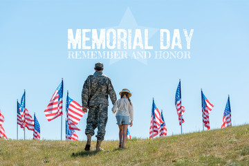 Canvas Print - back view of father in military uniform holding hands with daughter near american flags with memorial day illustration