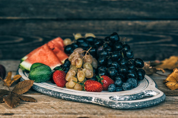 Wall Mural - Vintage tray with autumn fruits on rustic vintage table top view. Fresh organic fruits. Food background. Healthy food. Top view. Toned image.