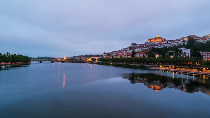 Wall Mural - Coimbra, Portugal. View of Coimbra, Portugal historical site from day to night. Time-lapse of car traffic with landmarks and reflectionint the river, cloudy sky, zoom in