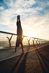 Wall Mural - Young man doing exercise early in the morning on a pathway