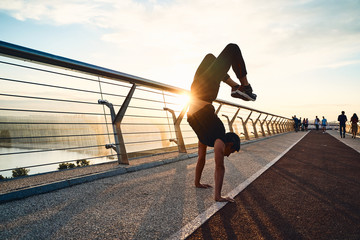 Wall Mural - Young man doing exercise early in the morning on a pathway