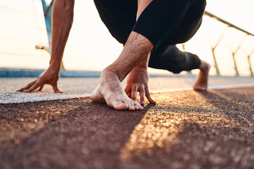 Wall Mural - Young man doing exercise early in the morning on a pathway